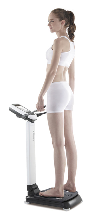 Woman using body composition analyzer for fitness and health tracking